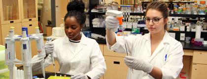 Two women in the lab, conducting experiments