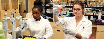 Two women in the lab, conducting experiments