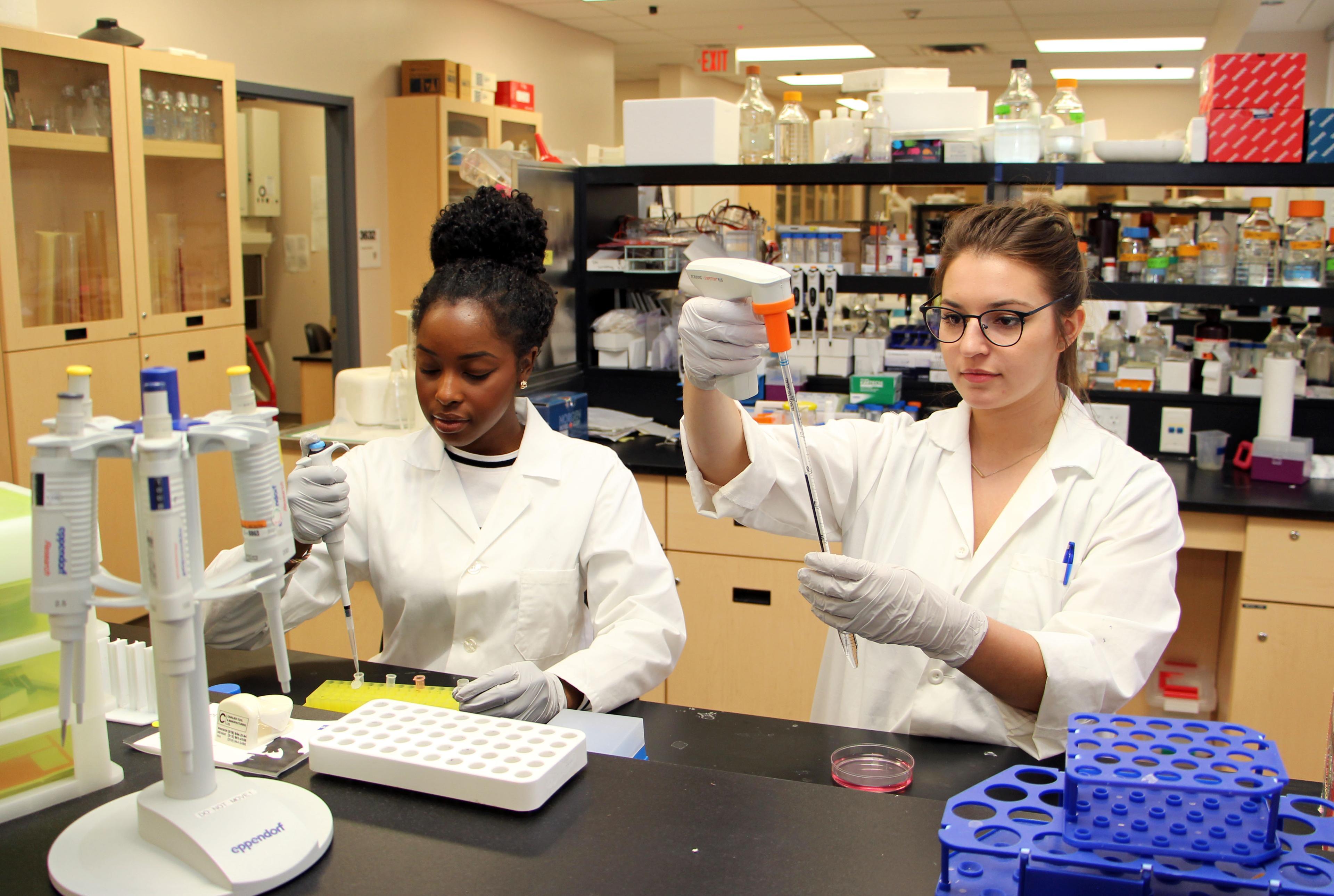 Two women in the lab, conducting experiments